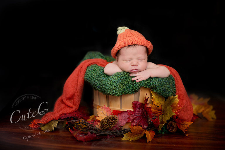 baby in pumpkin hat